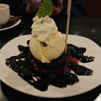 110 Grill - Gluten Free Flourless Cake - Chocolate Flourless Cake w/ Chocolate Sauce & Blueberries.  Topped with gelato & whipped cream. - New American Near Me - Woburn, Massachusetts