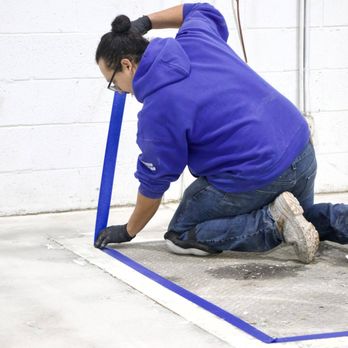 Floorguard - a woman in a blue hoodie using a blue tape - Flooring Near Me - Nerwark, Delaware Floorguard - a woman in a blue hoodie using a blue tape - Flooring Near Me - Nerwark, Delaware
