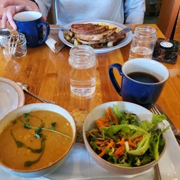 a person sitting at a table with food a person sitting at a table with food