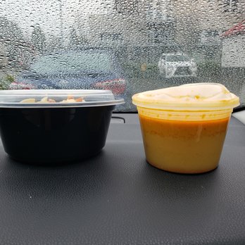 Reunion Malaysian Cafe + Kitchen - Warped plastic container with broth for our take out soup. - Malaysian Near Me - Kirkland, Washington