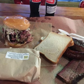 Franklin Barbecue - Pulled pork sandwich with slaw, wrapped pecan pie, brisket and sausage served with white bread. - Barbeque Near Me - Austin, Texas