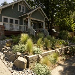Wild Oasis Landscapes - Cobble driveway, drainage basin, retaining walls