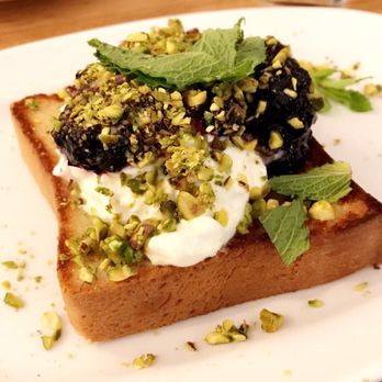 Atticus Bookstore Cafe - Brioche toast with stracciatella cheese, wild blueberry preserves, lemon, mint & pistachio - Coffee & Tea Near Me - New Haven, Connecticut Atticus Bookstore Cafe - Brioche toast with stracciatella cheese, wild blueberry preserves, lemon, mint & pistachio - Coffee & Tea Near Me - New Haven, Connecticut