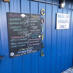River Rose Coffee - food items listed on board attached to north exterior side of building