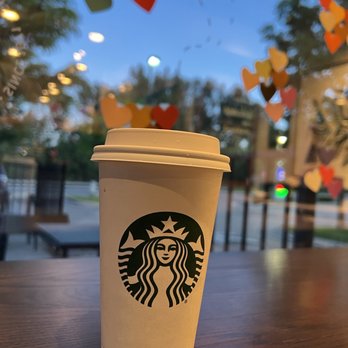 Starbucks - a cup of coffee on a table - Coffee & Tea Near Me - Missoula, Montana Starbucks - a cup of coffee on a table - Coffee & Tea Near Me - Missoula, Montana