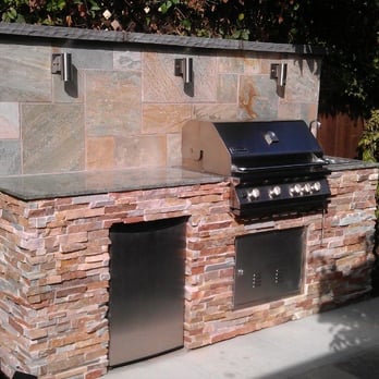 Kole's Tile - an outdoor kitchen with a grill - Flooring Near Me - San Marcos, California