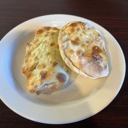 Spinach, onion and three cheese empanada and a Ham and cheese empanada. Spinach, onion and three cheese empanada and a Ham and cheese empanada.