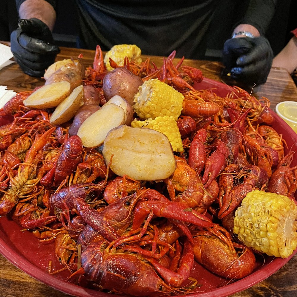 Texas Crawfish - crawfish, corn, potatoes and corn on a red plate - Food Trucks Near Me - Spring, Texas Texas Crawfish - crawfish, corn, potatoes and corn on a red plate - Food Trucks Near Me - Spring, Texas