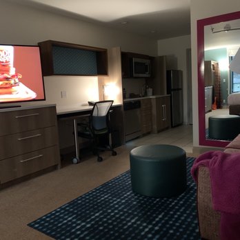 Home2 Suites by Hilton Corona - Facing living room area, kitchen area, and room entrance - Hotels Near Me - Corona, California