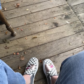 Red Schoolhouse Wines - two people sitting on a wooden deck - Beer, Wine & Spirits Near Me - Stone Lake, Wisconsin