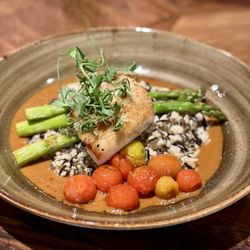 Tin Roof Bistro - Halibut with tomatoes, wild and long grain rice, lobster nage sauce, and pea tendrils