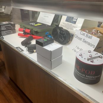 Gettysburg Ghost Tours - The display case contains ghost sensors, cat ball sensors, and related equipment, with informational signs and packaging visible. - Tours Near Me - Gettysburg, Pennsylvania