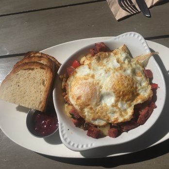 Beach Plum Kitchen - Pick a Hash-Corned Beef Hash breakfast potatoes, roasted garlic, red bell peppers & fresh herbs. Topped with 2 cage-free eggs And sourdough - New American Near Me - Carlsbad, California