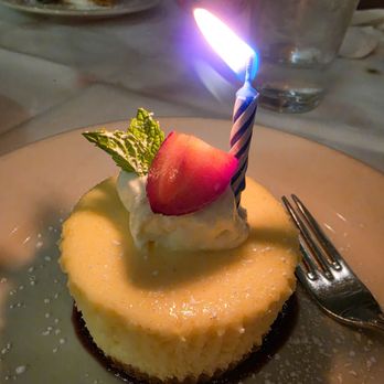 CF Food Kitchen - Cheesecake with a celebration candle - New American Near Me - Granada Hills, California