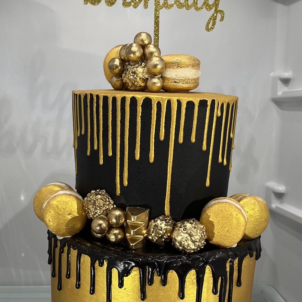 Dulce Luxe Bakery - Custom 2 tier black and gold cake. Flavor: White cake with Strawberry purée. - Desserts Near Me