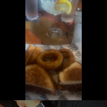 Ford's Garage Plano - Beef Brisket Sandwich with onion rings - Burgers Near Me - Plano, Texas Ford's Garage Plano - Beef Brisket Sandwich with onion rings - Burgers Near Me - Plano, Texas