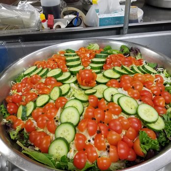 Zuri Qs BBQ - a salad with tomatoes and cucumbers - Caterers Near Me