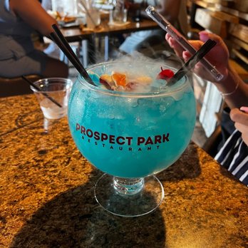 Prospect Park - a blue drink in a glass on a table - Sports Bars Near Me - Houston, Texas Prospect Park - a blue drink in a glass on a table - Sports Bars Near Me - Houston, Texas