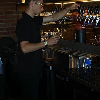The Bell in Scona - a bartender pouring a drink - Venues & Event Spaces Near Me - Edmonton, Alberta The Bell in Scona - a bartender pouring a drink - Venues & Event Spaces Near Me - Edmonton, Alberta
