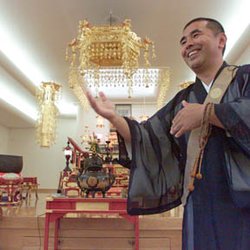 Nichiren Sect Mission of Hawaii - Reverend Hirai smiling inside Nichiren Shu hondo (temple)