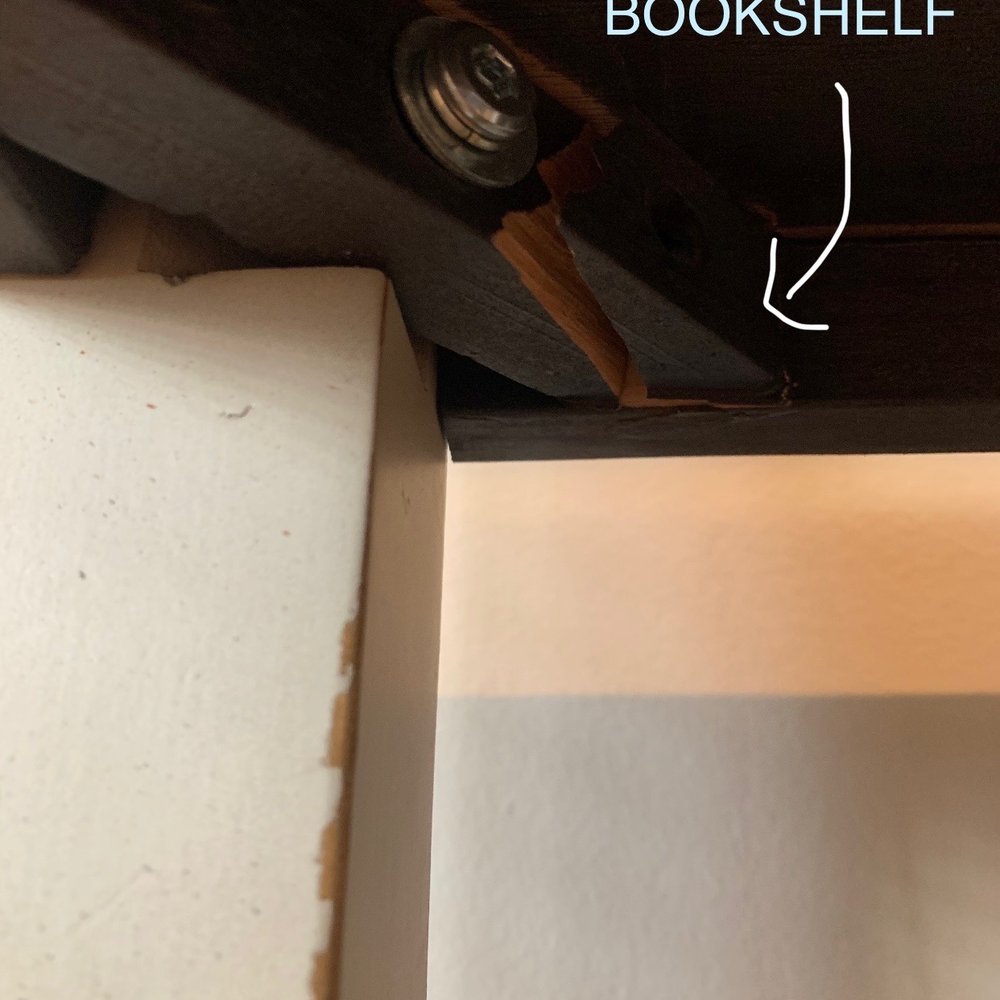Completely cracked bottom shelf of bookshelf Completely cracked bottom shelf of bookshelf
