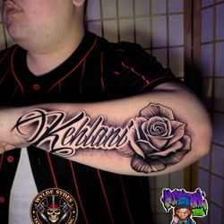 Wylde Sydes Tattoo & Body Piercing - Custom Lettering with Black and Gray Rose Tattoo