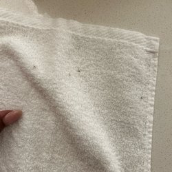 Unknown black stuff on towels hung for use