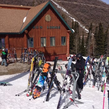 Sun Lodge - a group of skiers standing in front of a lodge - New American Near Me - Park City, Utah Sun Lodge - a group of skiers standing in front of a lodge - New American Near Me - Park City, Utah