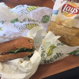 a sandwich and chips on a table