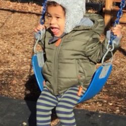 Seven Oaks Academy - Enjoying a swing during outdoor play.