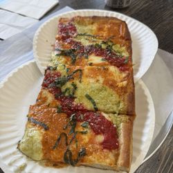 Sicilian rainbow pizza with red sauce, vodka sauce and pesto.