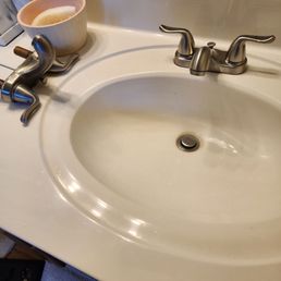 a sink with a toothbrush and soap dispenser a sink with a toothbrush and soap dispenser