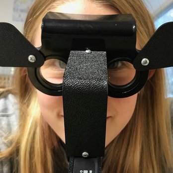 Advanced Family Eye Care - Patient looking through an optometry device - Eyewear & Opticians Near Me - Independence, Iowa Advanced Family Eye Care - Patient looking through an optometry device - Eyewear & Opticians Near Me - Independence, Iowa