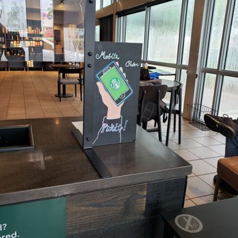 Starbucks - a sign in a coffee shop - Coffee & Tea Near Me - Hialeah, Florida