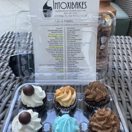 a tray of cupcakes on a table a tray of cupcakes on a table