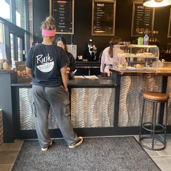 Java House - a woman standing at the counter - Coffee & Tea Near Me - Fishers, Indiana
