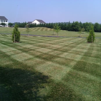 Mc Lawn Care - a view of a green lawn with a white house in the background - Snow Removal Near Me - Adamstown, Maryland Mc Lawn Care - a view of a green lawn with a white house in the background - Snow Removal Near Me - Adamstown, Maryland