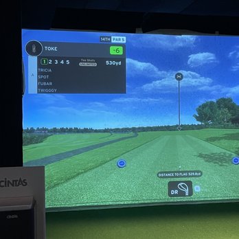 X-Golf Madison - a man playing golf on a large screen - Golf Near Me - Madison, Wisconsin