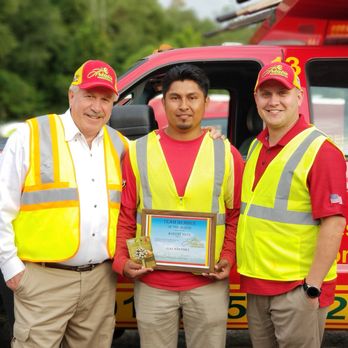 Artistic Landscaping - three men standing in front of a truck - Landscaping Near Me - Lanham, Maryland