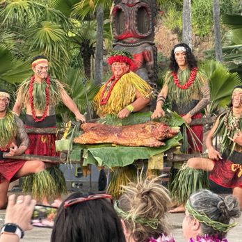 Chief's Luau - Chief and his crew posting for photos with the pig - Performing Arts Near Me - Kapolei, Hawaii