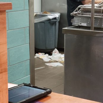 Taco Bell - There's a photo including trash in the kitchen area. There was food all over the floor previously but the trash was left upon the floor. - Tacos Near Me - Ebensburg, Pennsylvania