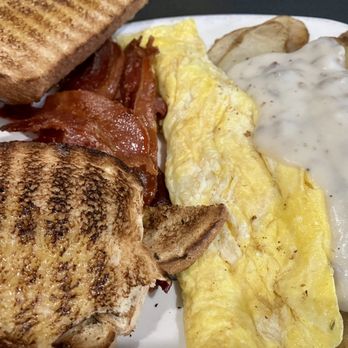 The Tick Tock Tavern & Eatery - Eggs, fried potatoes, crispy bacon, dab of sausage gravy, and wheat toast - American Near Me - Lafayette, Indiana