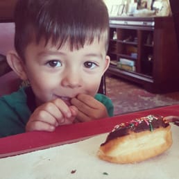 My nephew enjoying sprinkle doughnuts. My nephew enjoying sprinkle doughnuts.