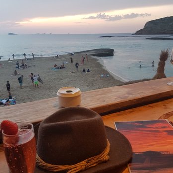 Sunset Ashram - View from the entrance of Sunset Ashram (with cloudy sunset) onto the beach - Spanish Near Me - Sant Josep de sa Talaia, PM Sunset Ashram - View from the entrance of Sunset Ashram (with cloudy sunset) onto the beach - Spanish Near Me - Sant Josep de sa Talaia, PM