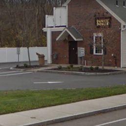 a brick building with a sign in front of it a brick building with a sign in front of it