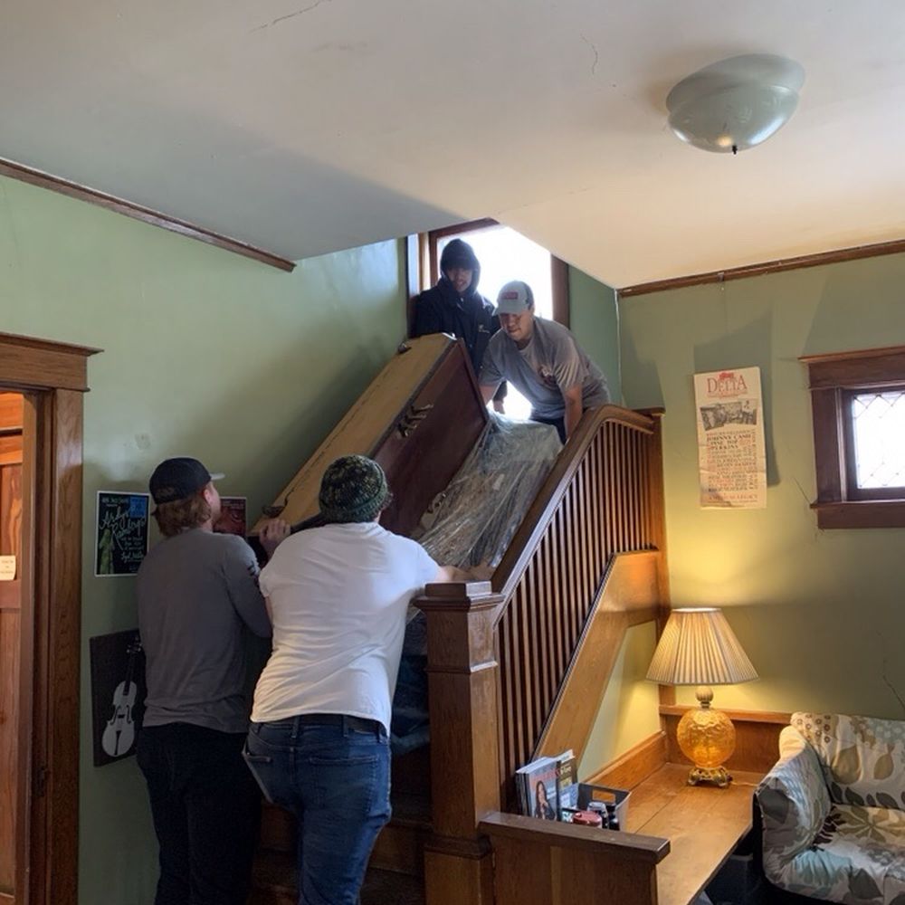 PDS Moving Delivery & Storage - Moving a studio upright piano down the stairs. - Movers Near Me - Lawrence, Kansas PDS Moving Delivery & Storage - Moving a studio upright piano down the stairs. - Movers Near Me - Lawrence, Kansas