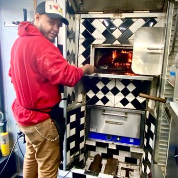 Hot Box Pizza MKE - Owner TJ putting my pizza in his brick/wood oven. - Pizza Near Me - Milwaukee, Wisconsin Hot Box Pizza MKE - Owner TJ putting my pizza in his brick/wood oven. - Pizza Near Me - Milwaukee, Wisconsin