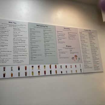Redstraw - Menu - The image shows a large, wall-mounted menu board divided into sections for milk tea, refreshing tea, smoothies, bingos, and custom tea. Each section lists various drink options with descriptions and prices. The bottom of the board features images of different drinks, providing visual references for customers. The setting appears to be inside a modern tea bar with minimalistic decor. - Bubble Tea Near Me - Irvine, California