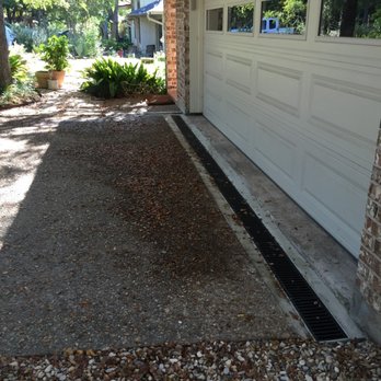Trench Drain Installed In Front Of Garage To Prevent Water