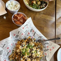 Bonchon South West Las Vegas - I got the bulgogi fries and my friend got the Bibimbap with tofu, we got sides of pickled radish and kimchi!